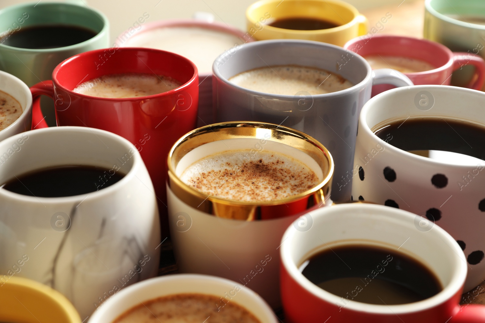 Photo of Many cups of different coffees on table, closeup