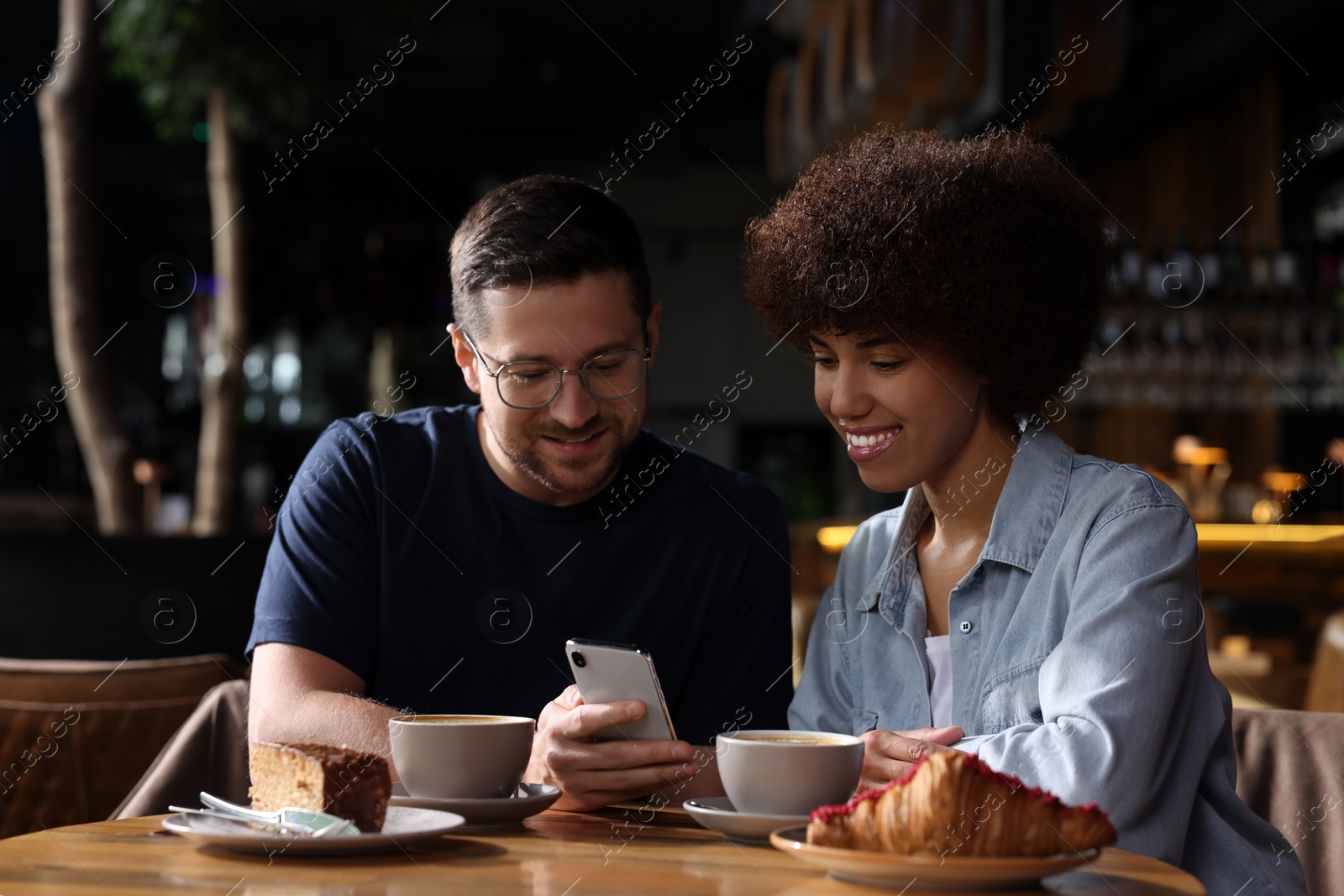 Photo of International dating. Lovely couple spending time together in cafe