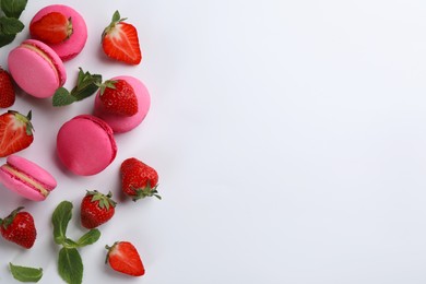 Photo of Flat lay composition with pink macarons, strawberries and mint on white background. Space for text