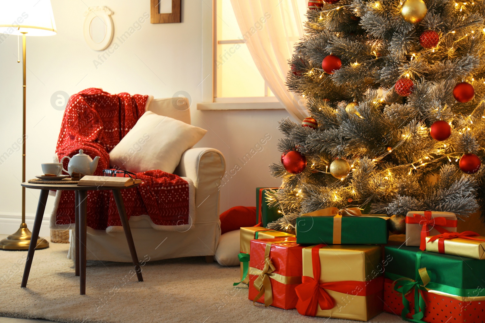 Photo of Stylish room interior with beautiful Christmas tree and gift boxes