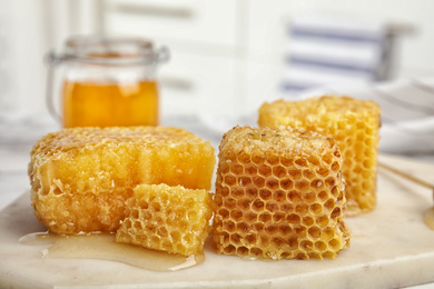 Photo of Fresh delicious sweet honeycombs on white board
