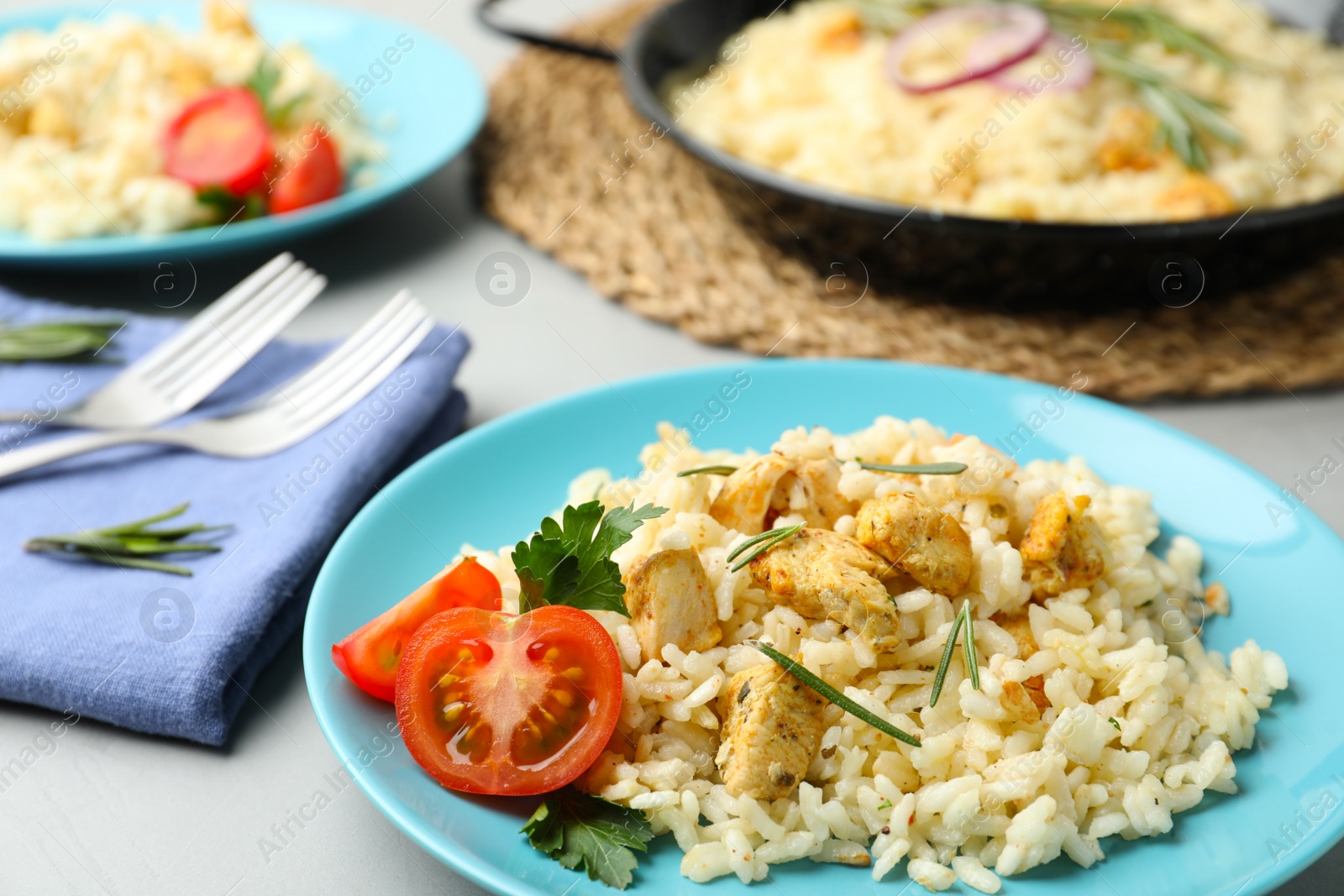 Photo of Delicious chicken risotto served on grey table