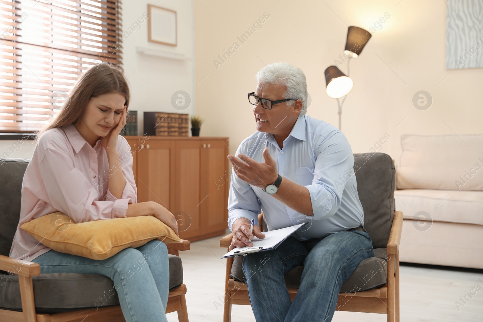 Photo of Professional psychotherapist working with patient in office