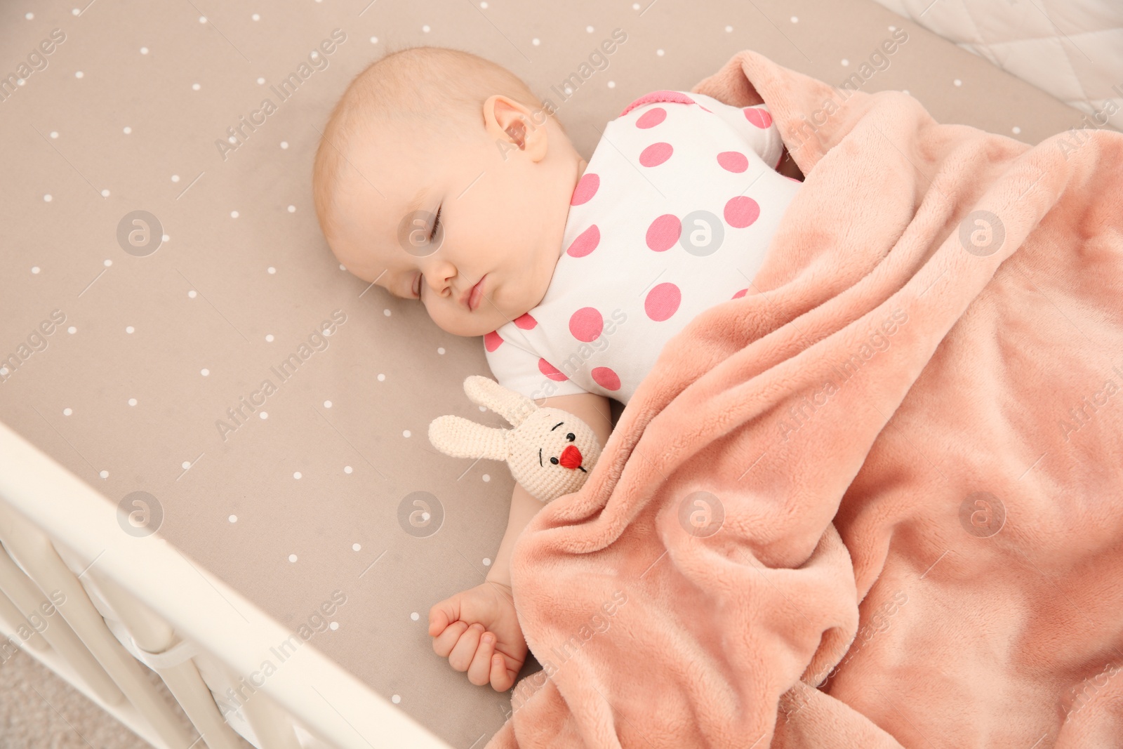 Photo of Cute baby girl sleeping in crib. Bedtime schedule