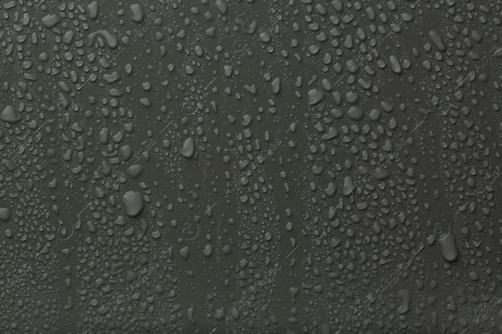 Photo of Many water drops on dark grey background