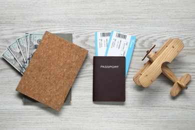 Photo of Flat lay composition with tickets, passport and dollars on white wooden table. Business trip