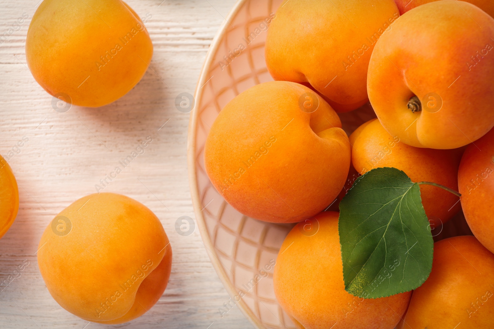 Photo of Composition with delicious ripe apricots on white wooden background, top view