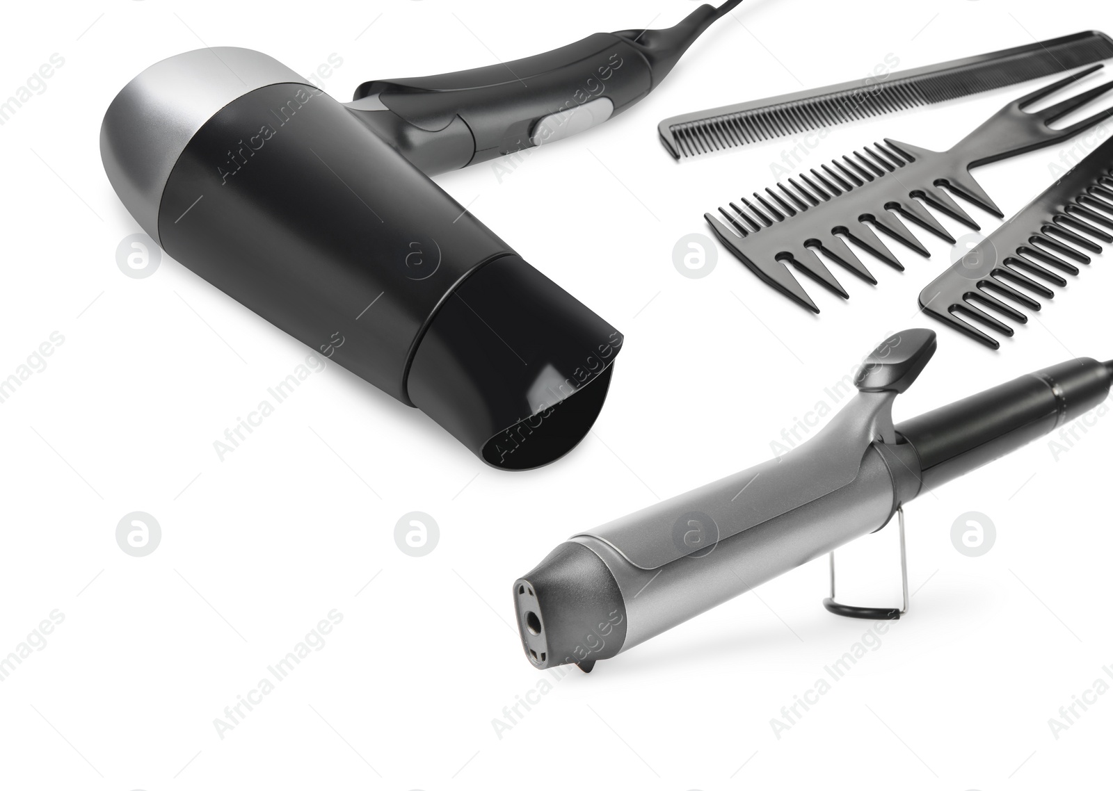 Image of Hair dryer, curling iron and combs on white background