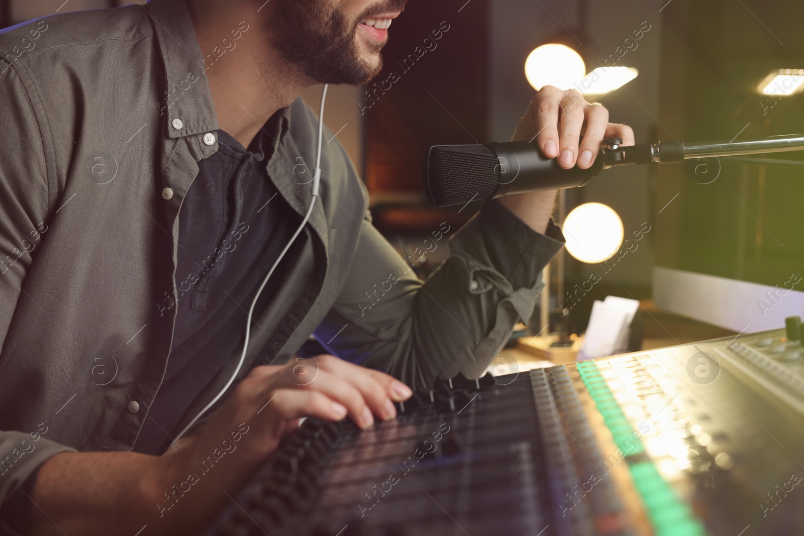 Photo of Man working as radio host in modern studio, closeup