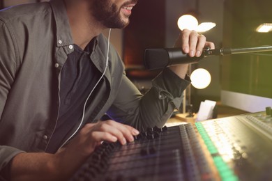Photo of Man working as radio host in modern studio, closeup