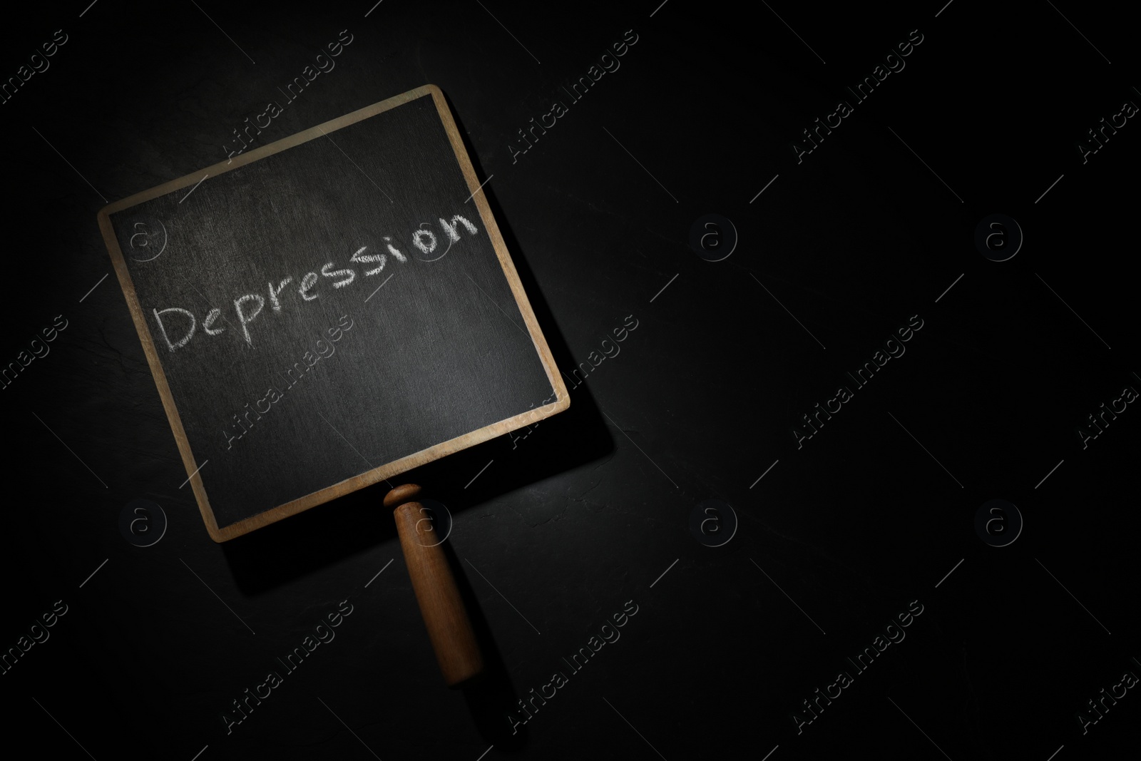 Photo of Chalkboard with word Depression in darkness, top view. Space for text