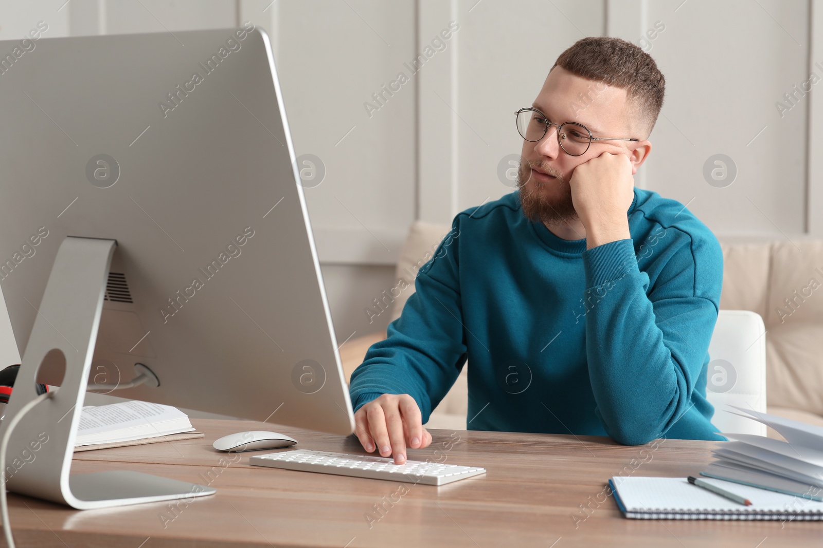 Photo of Online test. Man studying with computer at home