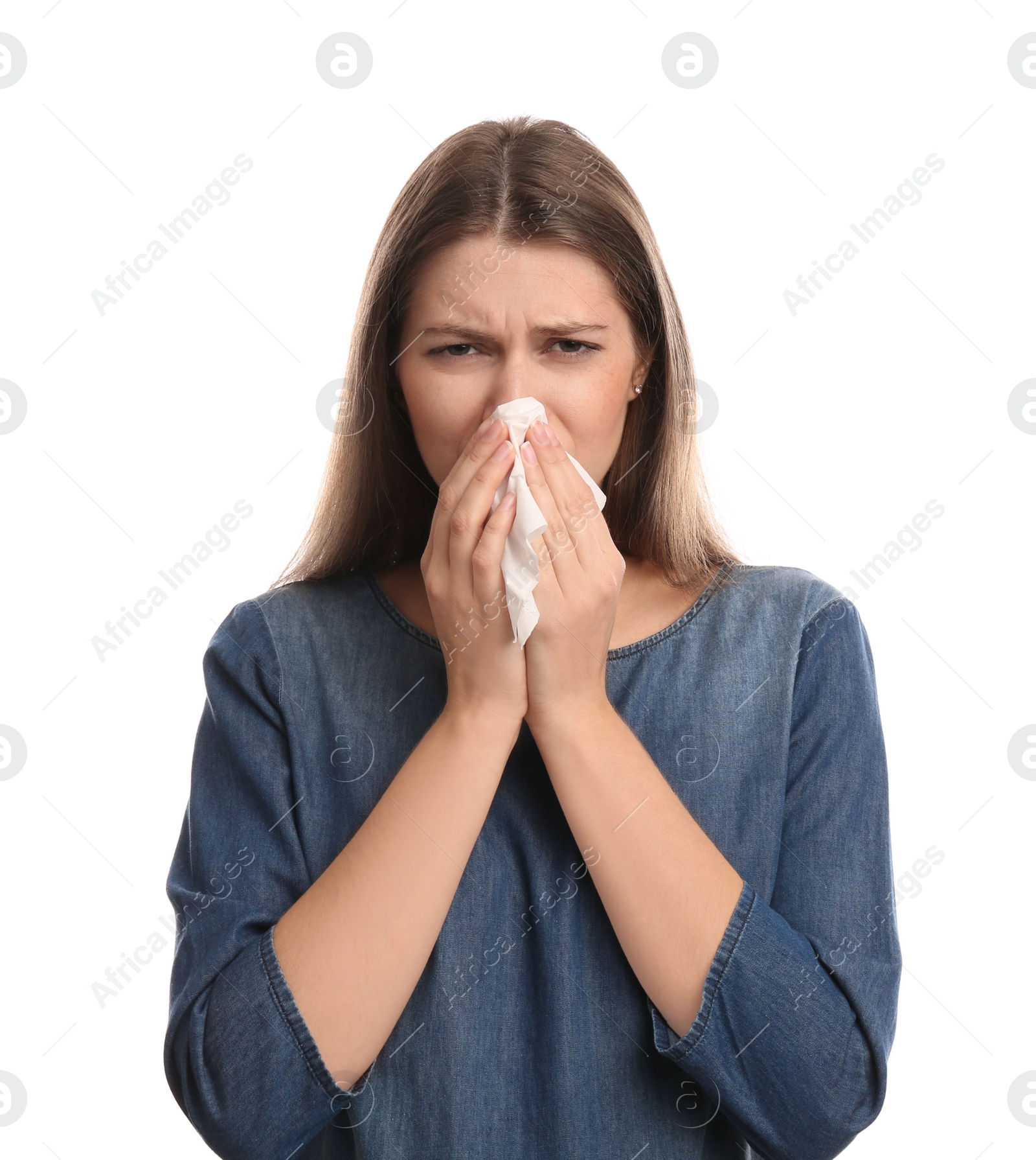 Photo of Young woman with tissue suffering from runny nose on white background