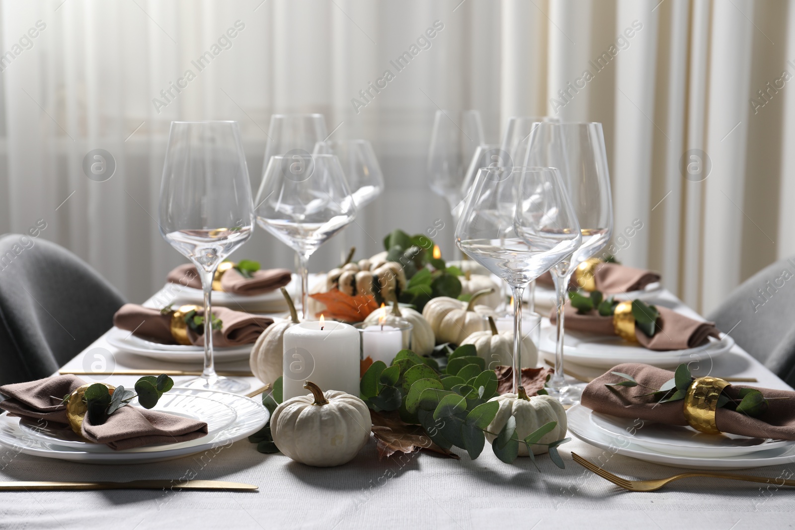Photo of Beautiful autumn table setting. Plates, cutlery, glasses and floral decor indoors