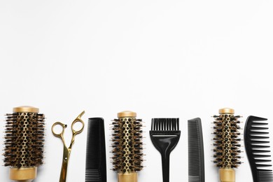 Photo of Hairdressing tools on white background, flat lay. Space for text