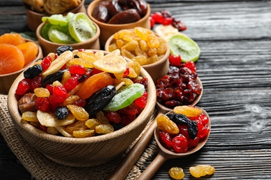 Photo of Composition with different dried fruits on wooden background, space for text. Healthy lifestyle