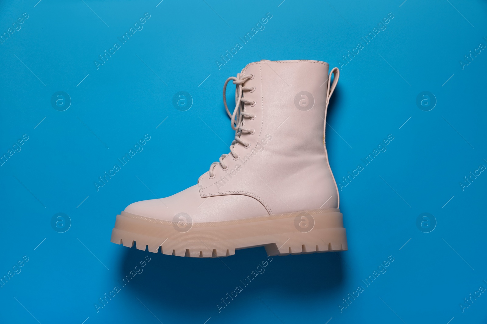 Photo of Stylish leather shoe on light blue background, top view