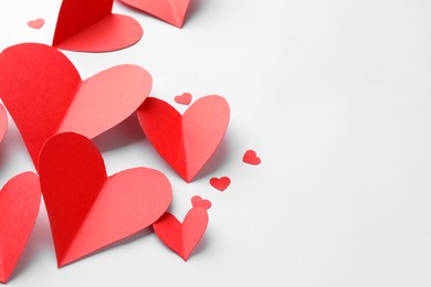 Photo of Paper hearts on white background, closeup. Space for text