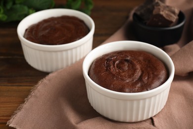 Photo of Delicious fresh chocolate fondant on wooden table, closeup