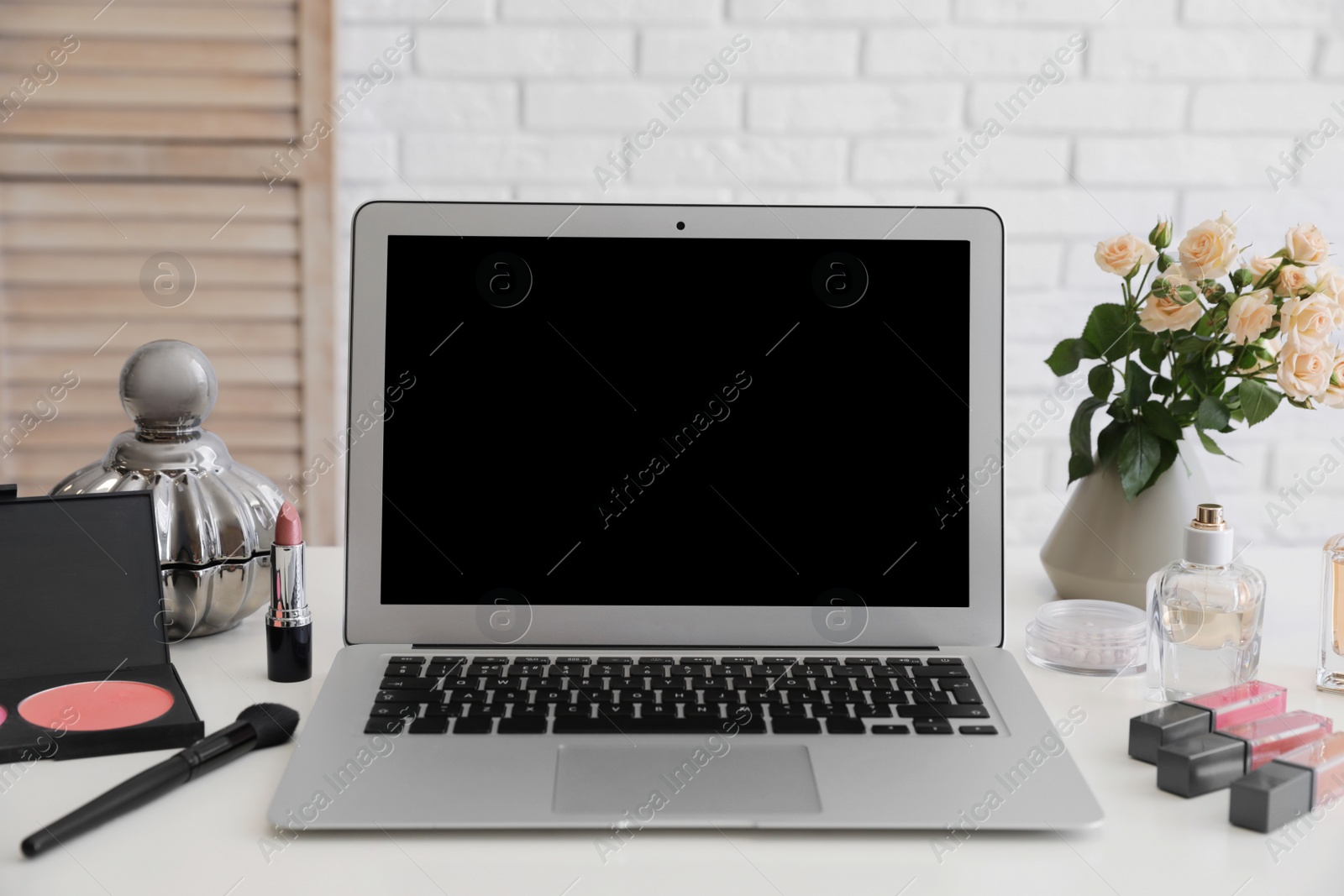 Photo of Blogger's workplace with modern laptop on table. Space for design
