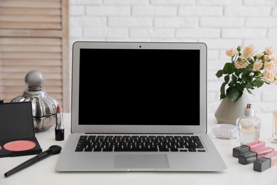 Photo of Blogger's workplace with modern laptop on table. Space for design