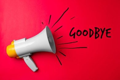 Image of Electronic loudspeaker and word Goodbye on red background, top view