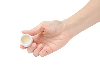 Photo of Woman holding jar of petroleum jelly on white background, closeup