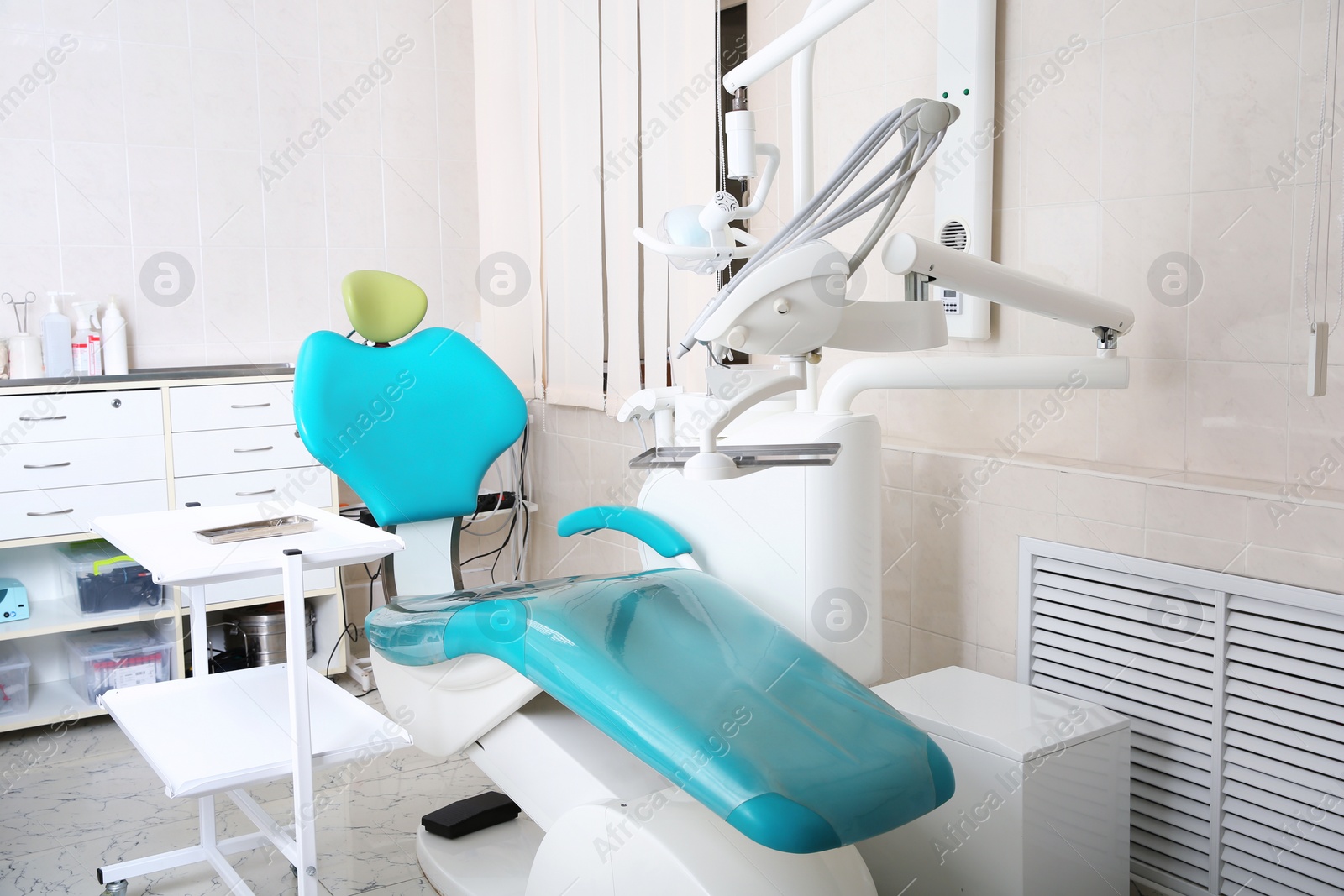 Photo of Dentist's office with modern chair and professional equipment