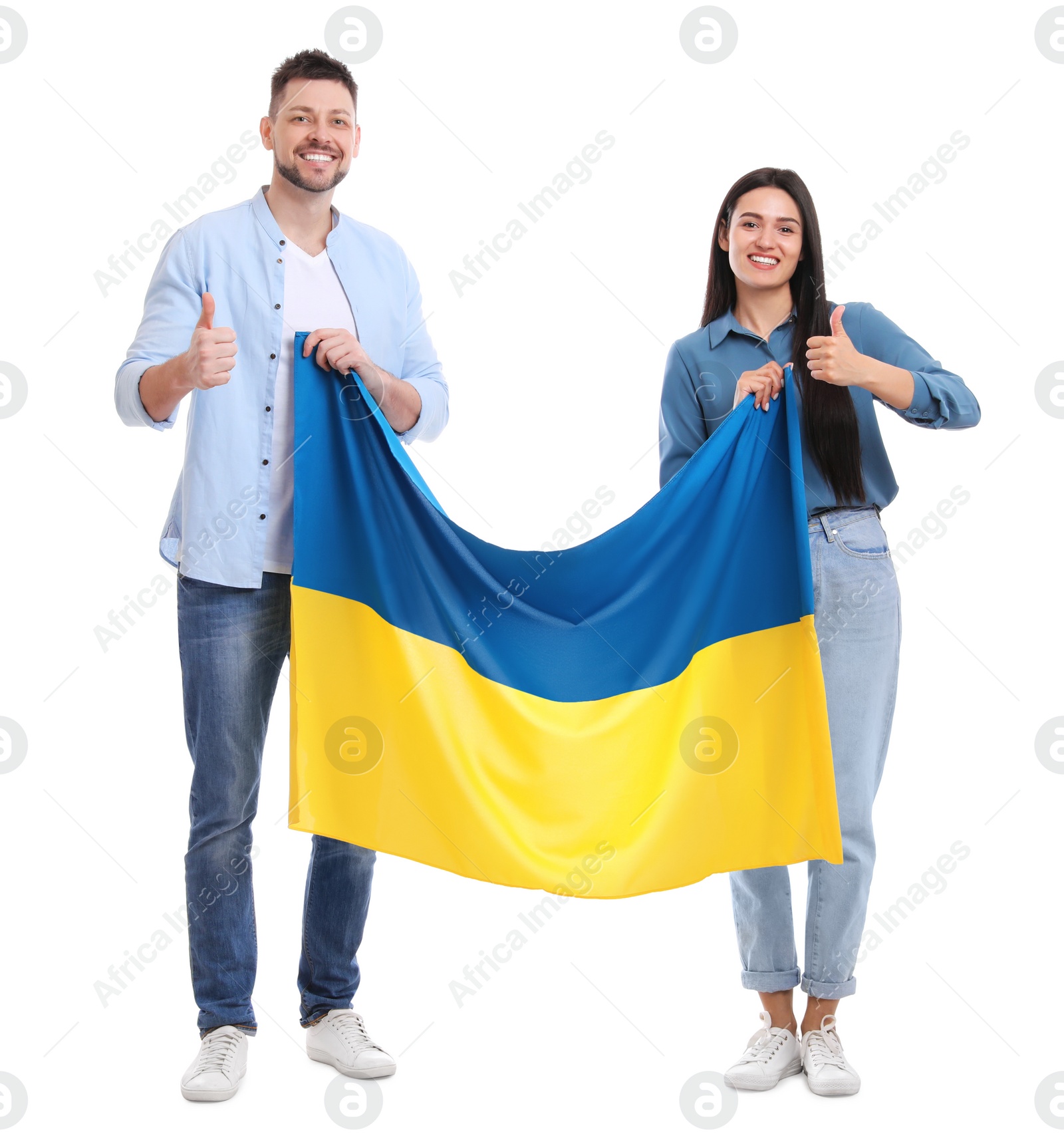 Photo of Happy couple with flag of Ukraine on white background