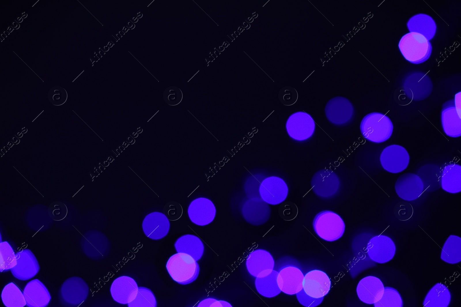 Photo of Blurred view of lights on black background, space for text. Bokeh effect