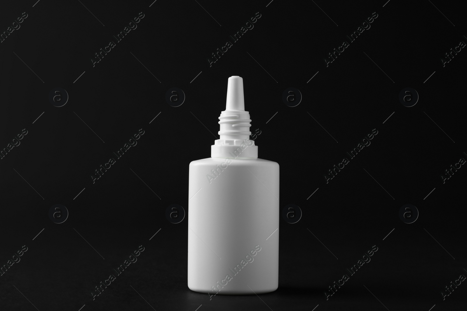 Photo of Bottle of nasal spray on black background