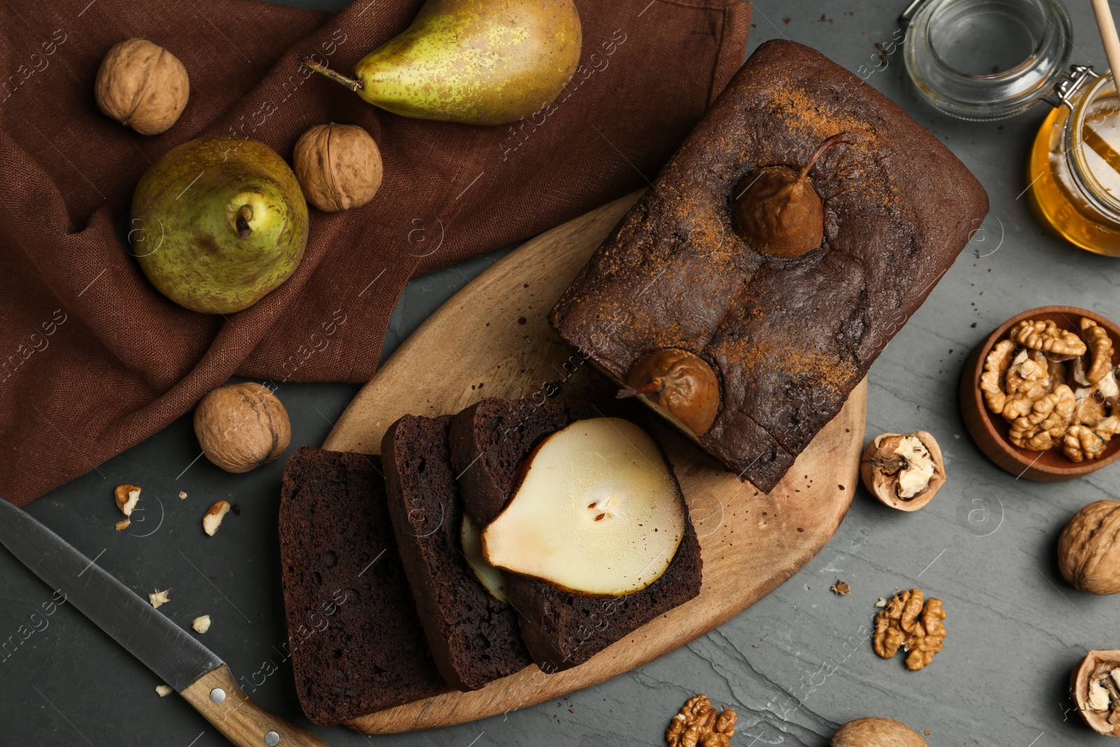 Photo of Flat lay composition with tasty pear bread on black table. Homemade cake