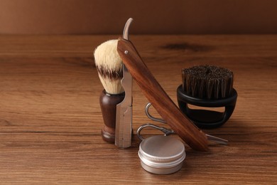 Moustache and beard styling tools on wooden table