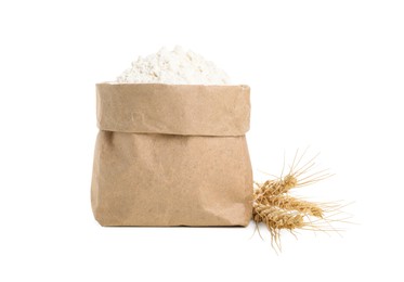 Photo of Paper bag with wheat flour and spikes isolated on white