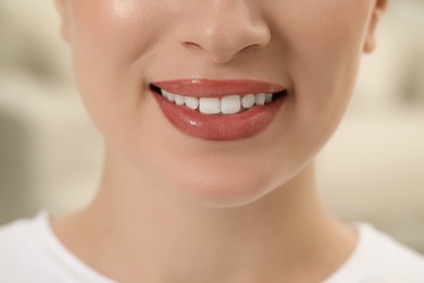 Photo of Woman with healthy teeth on blurred background, closeup