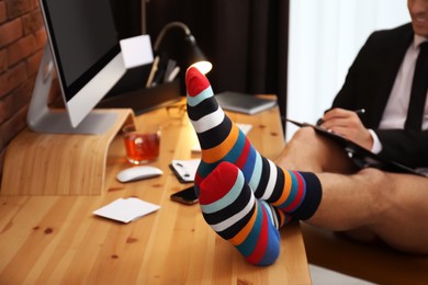 Photo of Businessman in jacket and underwear near computer at home office, closeup