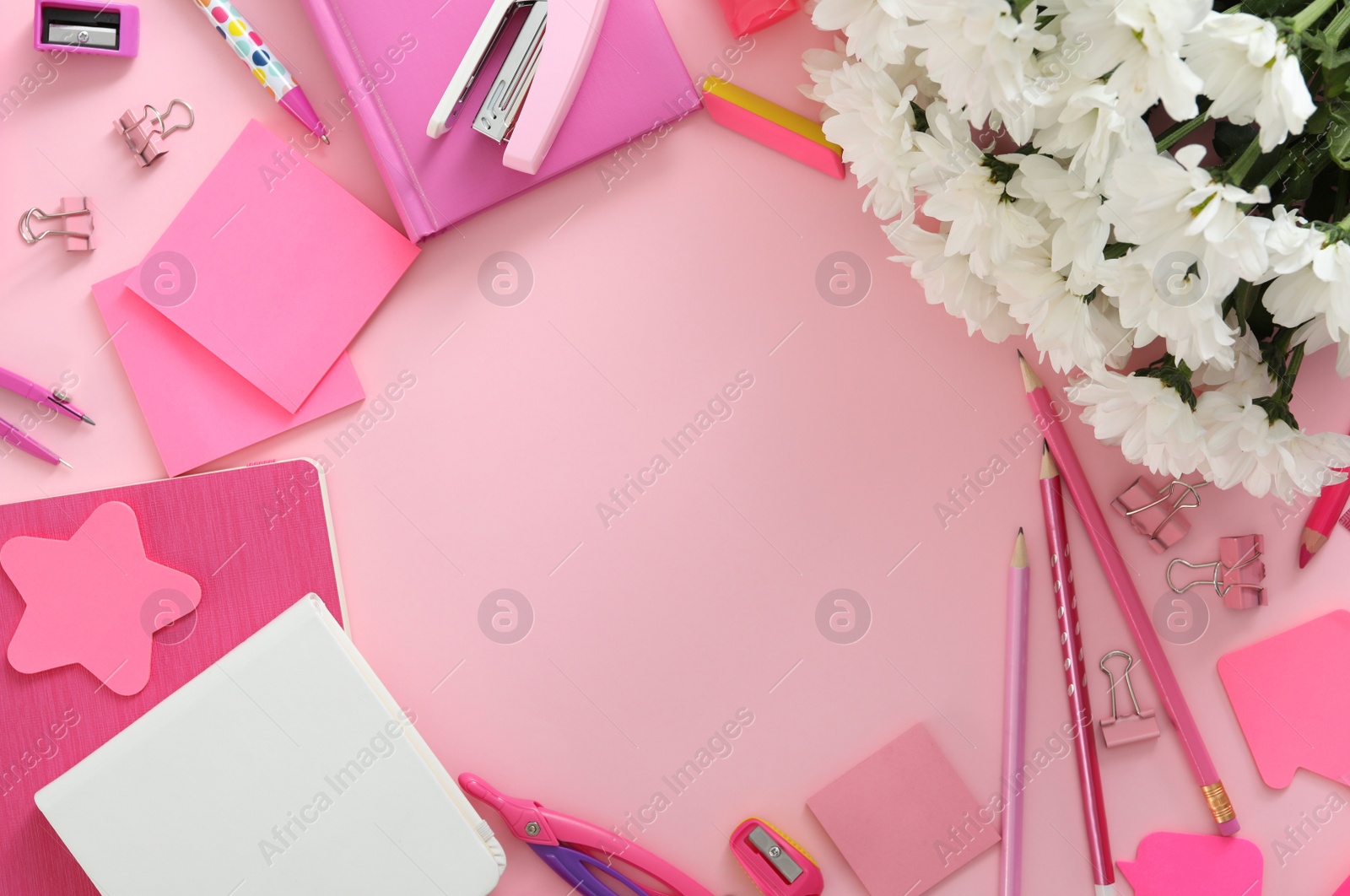 Photo of Frame made of flowers and stationery on pink background, flat lay with space for text. Teacher's Day