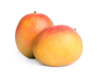 Delicious ripe juicy mangoes on white background