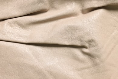 Beige natural leather as background, top view