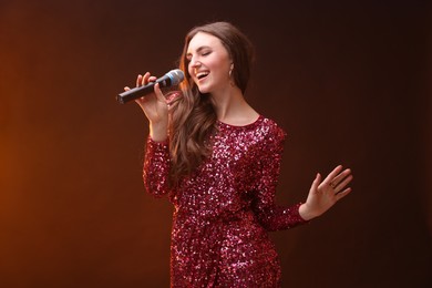 Emotional woman with microphone singing in color lights