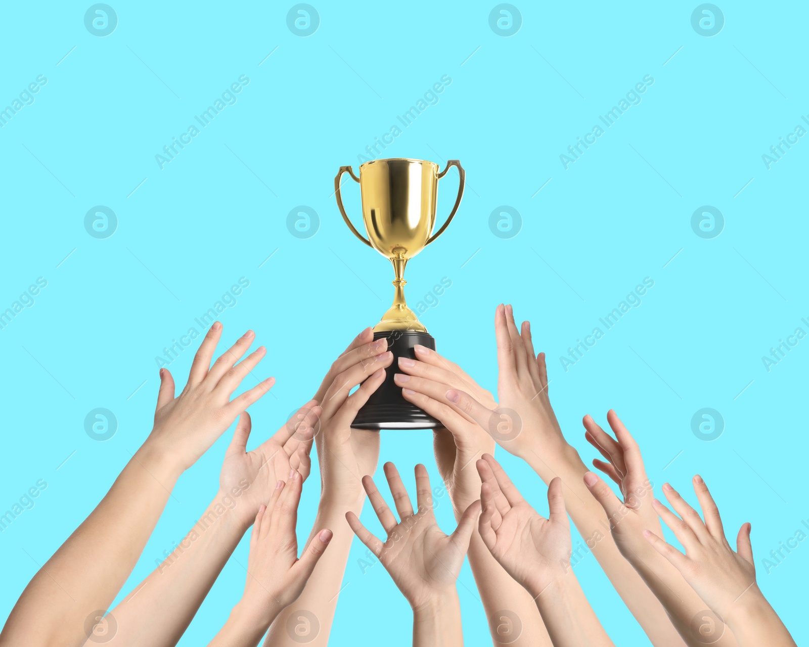 Image of People with golden trophy cup on turquoise background, closeup