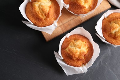 Tasty muffins on grey table, flat lay. Space for text