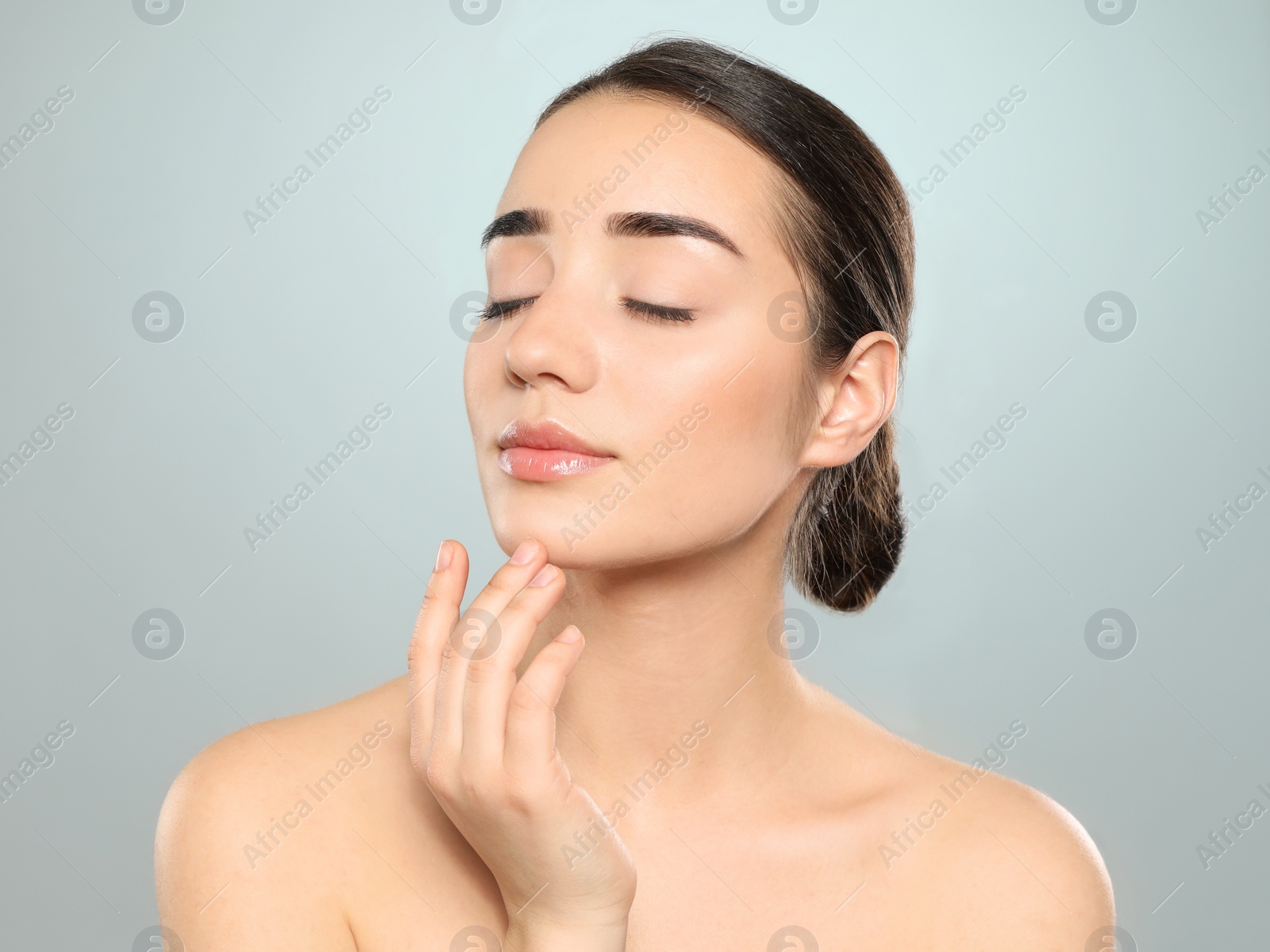 Photo of Portrait of young woman with beautiful face against color background