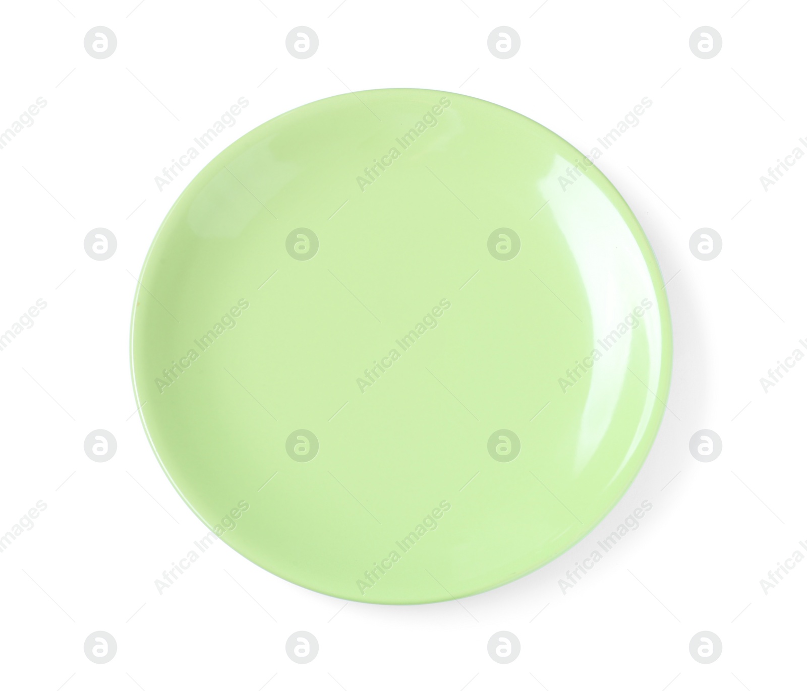 Photo of Empty light green ceramic plate isolated on white, top view