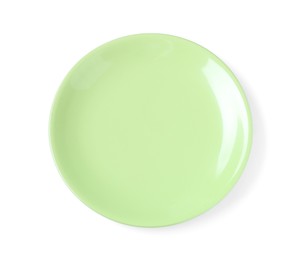 Photo of Empty light green ceramic plate isolated on white, top view