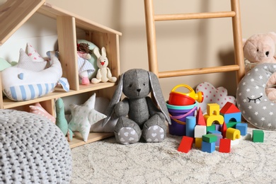 Photo of Different child toys on floor against color wall