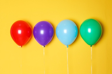 Different balloons on color background. Celebration time