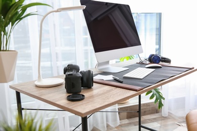 Photo of Light modern interior of working place with computer
