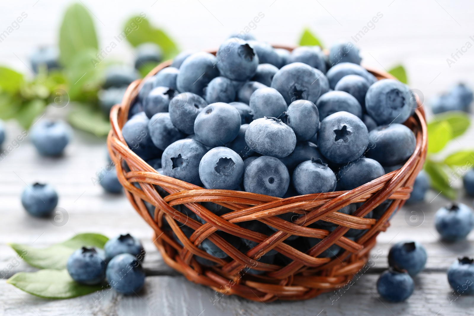 Photo of Tasty fresh blueberries on wooden table, closeup