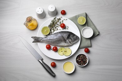 Photo of Flat lay composition with raw dorado fish and spices on white wooden table